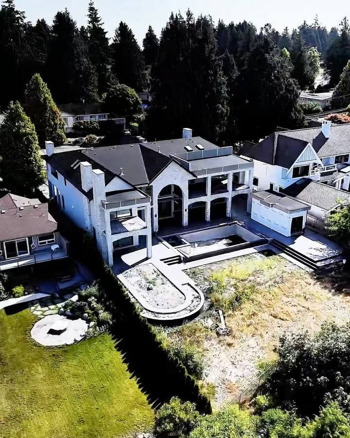 Aerial view of a finished home with new concrete work around the pool area in Tsawwassen